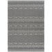 A grey and white woven rug with a geometric pattern.