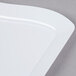 A white rectangular Fineline dessert plate with curved edges.