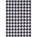 An Abani Parker Collection cream rug with a black and white houndstooth pattern and white border.