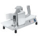 A Nemco 3/8" Easy Tomato Slicer with a metal surface and white plastic pieces.