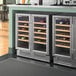 AvaValley commercial beverage cooler with glass doors filled with wine bottles.