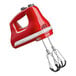 A red KitchenAid 6-speed hand mixer with flex edge beaters.