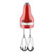 A KitchenAid Empire Red hand mixer with black handles.