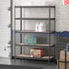 A Lavex black boltless shelving unit with shelves holding bottles and containers.