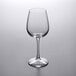 A clear Libbey Vina tall wine glass on a white surface.
