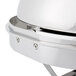 A Vollrath New York Drop-In Round Retractable Dripless Chafer with Brass Trim. A close up of a silver Vollrath chafer with a lid.
