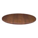A close-up of a Perfect Tables dark walnut woodgrain round table top.