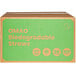 A green OMAO box with orange text containing 500 wrapped biodegradable straws.
