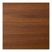 A close-up of a Perfect Tables 24" round light walnut woodgrain table top.