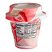 A Del Monte strawberry parfait yogurt container with a label.