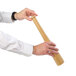 A person holding a wooden baseball bat with a pepper mill on the end.