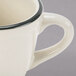 A CAC ivory china cup with a scalloped edge and black rim.