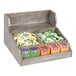 A Cal-Mil gray-washed pine wood condiment organizer on a counter with a variety of tea bags inside.