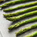 A pan of asparagus spears on a baking sheet.