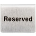 A Tablecraft stainless steel reserved tent sign on a table.