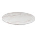 A white marble Perfect Tables round table top with pink veins.