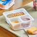 A tray with cheddar and turkey on crackers.