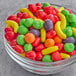 A bowl of Runts candy on a table.