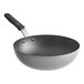 A black Vollrath stir fry pan with a black handle.