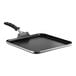 A Vollrath stainless steel griddle with a black Ceramiguard II coating and a black silicone handle.