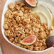 A bowl of Nature Valley Oats and Honey Parfait Granola with yogurt and figs.