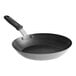 A black Vollrath frying pan with a black silicone handle.