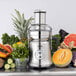 A Breville commercial juicer in use with a pineapple and other fruits.