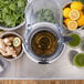 The Breville Commercial Juice Extractor juicing green vegetables and lemons.