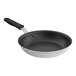 A black and white Vollrath Wear-Ever frying pan with a black silicone handle.