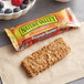 A Nature Valley Peanut Butter Crunchy Granola Bar on a counter.