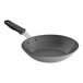 A close-up of a Vollrath carbon steel frying pan with a black handle.