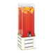 A Cal-Mil beverage dispenser with orange juice and orange slices on a white and gold metal base.
