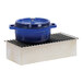 A blue pot with a lid on a white-washed pine wood chafer alternative rack.