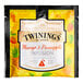 A yellow and black Twinings packet of mango and pineapple infusion tea sachets.