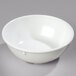 A white Carlisle Dallas Ware nappie bowl on a gray surface.