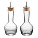 Two clear glass Barfly bitters bottles with cork tops.