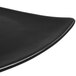 A black CAC Festiware triangle flat plate with a curved edge.