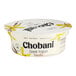 A white Chobani Greek yogurt container with black text and yellow flowers on the lid.