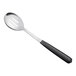 A Vollrath stainless steel slotted basting spoon with a black Kool-Touch handle.