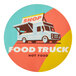 A white circular sticker with a food truck and the words "hot food" on it.