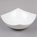 An American Metalcraft white stoneware square bowl on a gray surface.