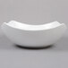 An American Metalcraft white stoneware bowl with a curved shape on a gray background.