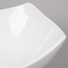 A close-up of an American Metalcraft white square stoneware bowl.