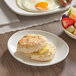 A Bakery Chef classic Southern baked buttermilk biscuit on a plate next to a bowl of fruit.