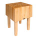 A John Boos maple butcher block table with wooden legs.