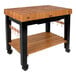 A John Boos cherry wood portable work table with undershelf and drawer on wheels.