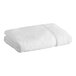 A rolled white Lavex Premium bath sheet.