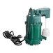 A green Zoeller M73 sump pump with a white cord.