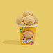 A cup of Eclipse Foods vegan mango passion fruit ice cream with a scoop of ice cream on top.