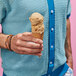 A person holding an ice cream cone with Eclipse Foods Vegan Cookie Butter Ice Cream.
